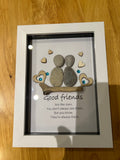 Two pebble friends on driftwood with wooden hearts and teal gems, good friends are like stars quote shadow box frame