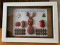 Handmade pebble art frame featuring Rudolph the reindeer and two robins with a Merry Christmas sentiment