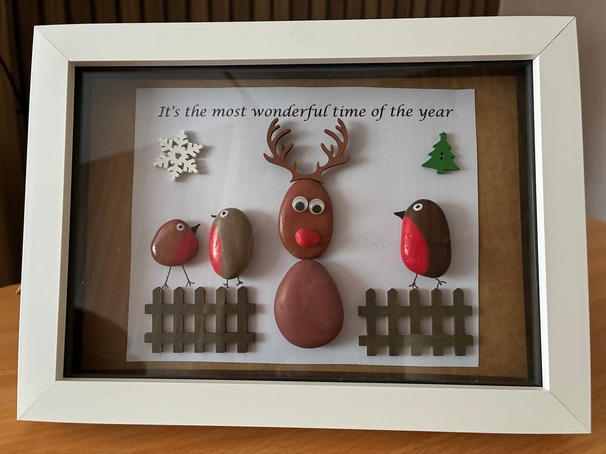 Handmade pebble art frame featuring Rudolph the reindeer and two robins with a Merry Christmas sentiment