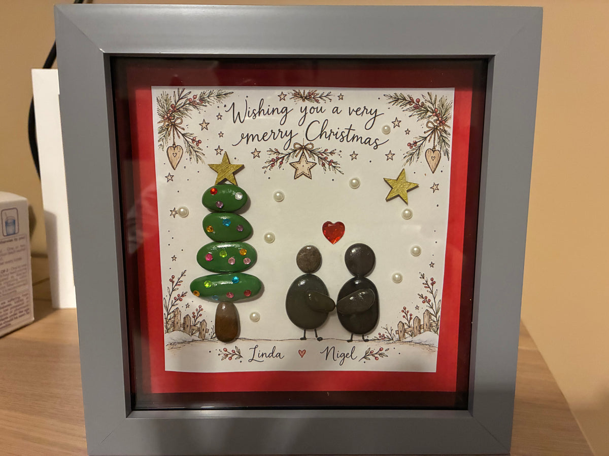 Personalised Christmas pebble art couple frame with names Linda and Nigel, featuring a pebble Christmas tree and heart